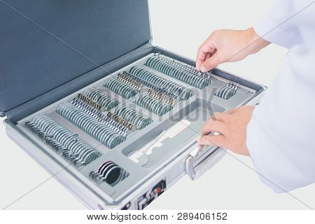 Optician Male Hands Choose Lenses From Set Of Corrective Lens Indicating On The Plates Of The Shape: