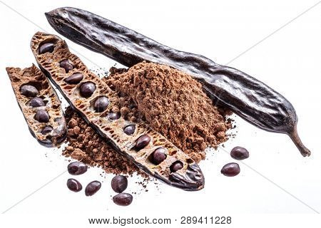 Carob pods and carob powder on the white background.