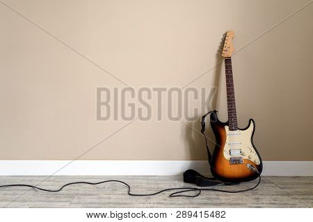 Sambir, Ukraine - February 2019,  Fender Squier Bullet Strat model guitar in sunburst with black cable closeup