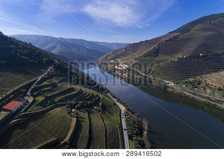 Aerial View Of The Terraced Vineyards In The Douro Valley And River Near The Village Of Pinhao, Port