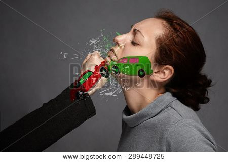 The Concept Of A Car Accident, Insurance.a Staged Car Accident Involving A Girl's Face And A Blow To
