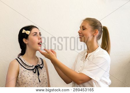 The Speech Therapist Works With The Patient Over The Speech, Showing The Logopedic Probe The Positio