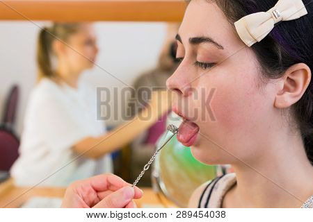 The Speech Therapist Makes A Tongue Massage To The Patient By A Special Probe