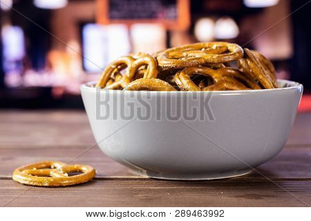Lot Of Whole Mini Salted Pretzels In A Grey Ceramic Bowl In A Restaurant