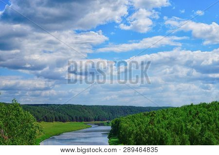 Clear Sky With Green Trees Along Fast River