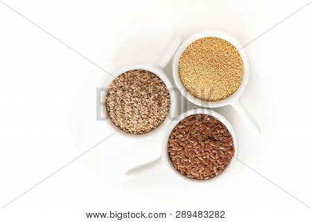 Healthy Food Ingredents 3 Kind Of Gluten Free Grains Flax, Amaranth And Sesame Seeds On White Backgr