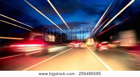 Driving Fast On The Highway Or German Autobahn At Night, Cars And Lights With Motion Blur