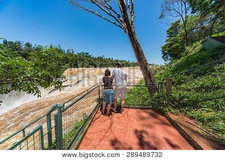 Man And Woman On The Saltos Del Monday A Waterfall Near The City Ciudad Del Este In Paraguay