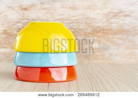 Ceramic Bowl Assorted Colors On Wooden Background