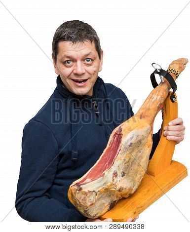 Man Holds A Spanish Serrano Ham On Thigh With Wood Holder