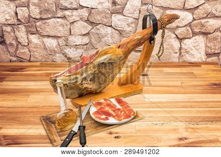 Spanish Serrano Ham On The Leg With Wood Holder On A Table