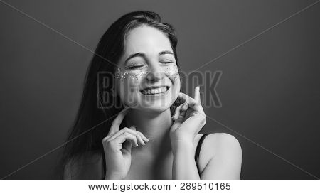 Young Woman Portrait. Fake Female Smile. Eyes Closed. Black And White Headshot.