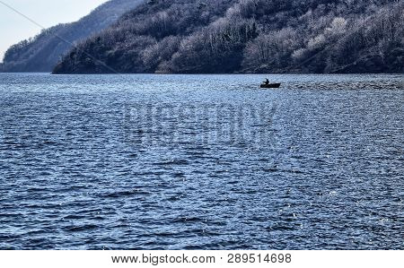 Mergozzo, Piedmont, Italy. March 2019. A Fisherman With His Boat