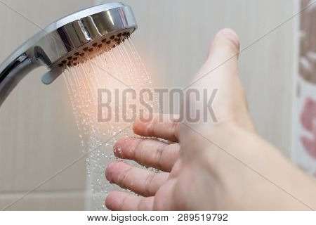 Check The Temperature Of The Water Mans Hand Cold And Hot Water