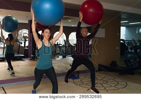 Fitness Parners In Sportswear Doing Exercises At Gym. Fitness Sport Gym Concept