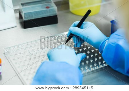 Gloved Hand Marks Lab Samples On Laboratory Table At Research Institute In Net Laboratory T Virtus
