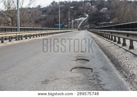 Pothole In The Center Of A Busy City Street.