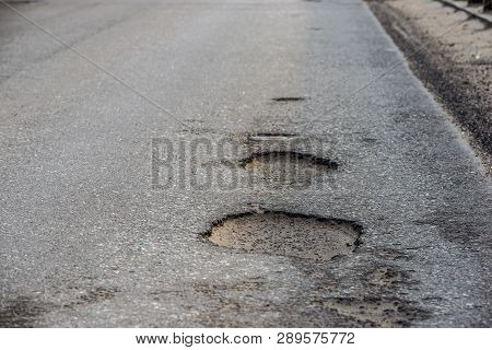 Pothole In The Center Of A Busy City Street.