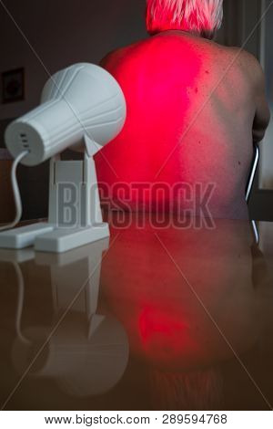 Infrared Radiation Heat Lamp Therapy. Senior Back Pain