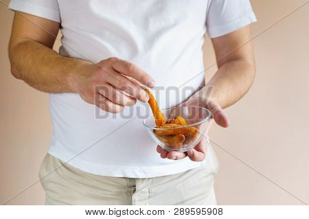 Processed Products, Fast Food, Unhealthy Diet, Imbalanced Ration. Overweight Man Eating Chicken Nugg