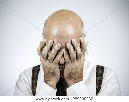 Desperate Mature Man With Head In Hands