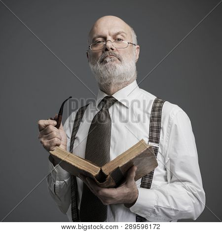 Senior Academic Professor Reading And Smoking A Pipe