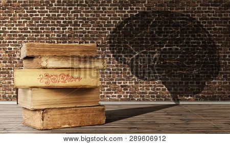 The Concept Of Education. A Pile Of Old Books Casts A Shadow In The Form Of A Brain On Brick Wall Ba