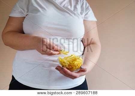 Processed Products, Fast Food, Unhealthy Diet, Imbalanced Ration. Overweight Woman Eating Salted Fat