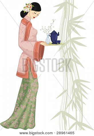 Krásná Číňanka drží tác s tea set