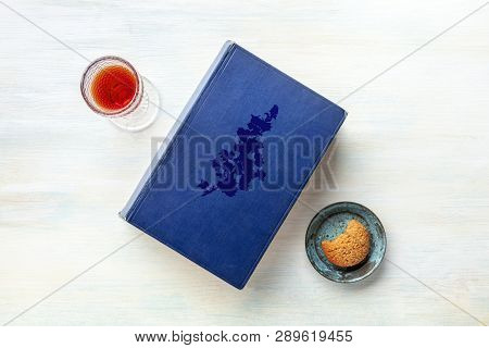 An Old Book With A Glass Of Dessert Wine And A Cookie, Shot From Above With A Place For Text