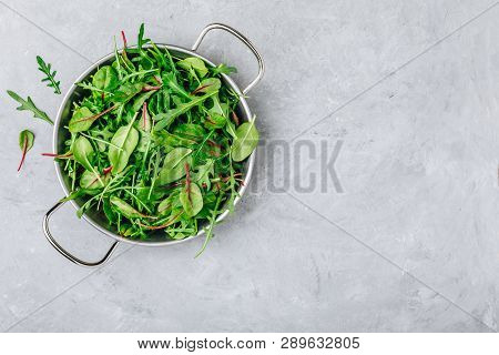 Mix Of Fresh Leaves With Arugula, Lettuce, Spinach, Beets. Ingredients For Salad On A Gray Stone Bac