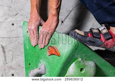 Rocky Shoe On A Tiny, Scanty Snare Stands With The Tip Of The Sock In Close-up On The Climbing Wall 