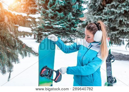 Beautiful Girl In A Blue Jumpsuit, In The Winter At The Resort, A Board Harness, Checks The Mount, S