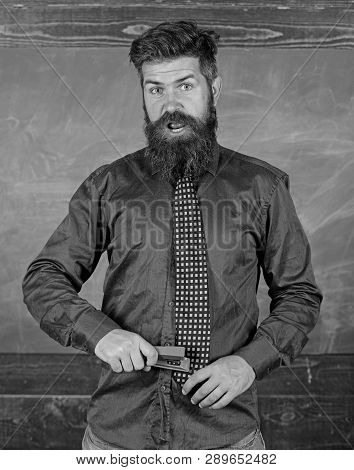 School Accident Prevention. Teacher Bearded Man With Pink Stapler Chalkboard Background. School Stat
