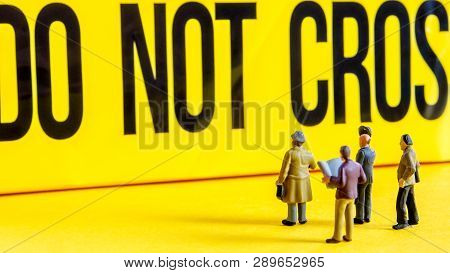 Do Not Cross Line With Little Miniature Figurines Standing In Front Of The Tittle And Looking At It,
