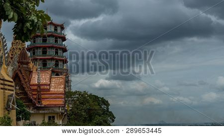 Wat Tham Suea With Threatening Storm Clouds In The Background
