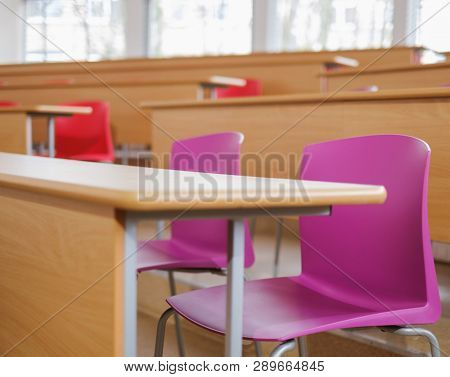 Auditorium interiror with chairs and desks