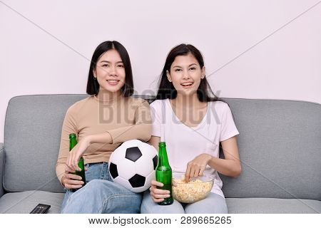 Concept Of Cheering. Asian Teenagers Watching Football On Television. People Are Cheering And Winnin