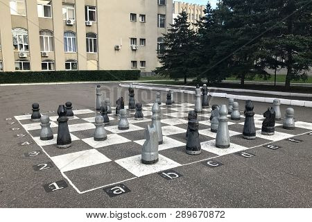 Penza, Russia - August 3, 2017: Chessboard Painted On Asphalt And Chess Pieces In Penza, Russia. Hug
