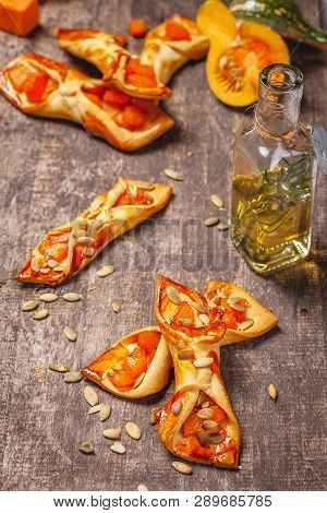 Small Biscuits With Pumpkin On Wooden Rustic Table. Close Up