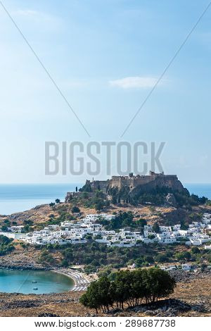 View Of The Acropolis Of Lindos Above The Lindos Village On A Hot Summer Day.