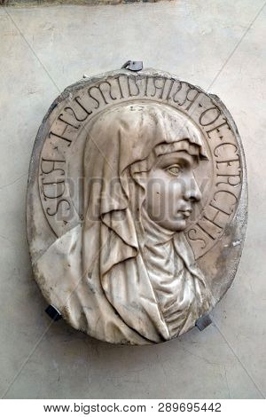FLORENCE, ITALY - JANUARY 10, 2019: Portrait of the blessed Umiliana de Cerchi, bas relief in white marble, Basilica di Santa Croce (Basilica of the Holy Cross) in Florence, Italy