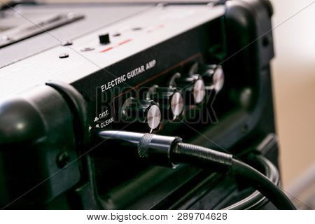 Guitar Amplifier With Dials And Controls For Volume, Gain, Bass, Treble. Jack Cable Connected. Black