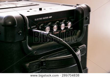 Guitar Amplifier With Dials And Controls For Volume, Gain, Bass, Treble. Jack Cable Connected. Black