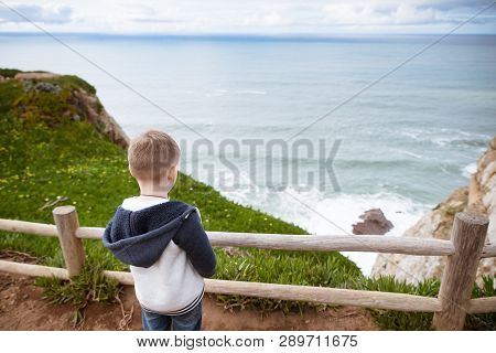 Little Boy Looks At The Atlantic Ocean.