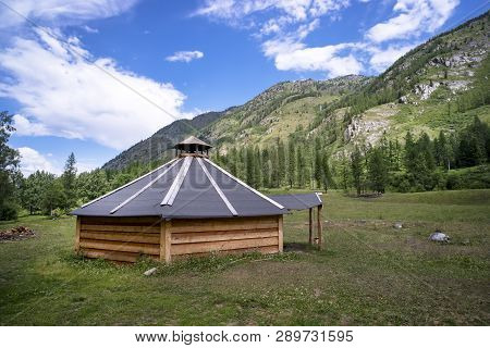 Ail. Traditional Mongolian Portable Round Tent Ger Covered With White Outer Cover In Altai Mountains