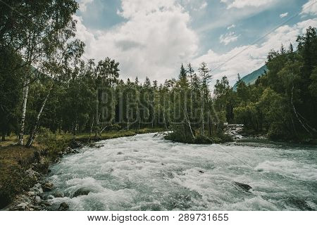 The Fast Flowing Crystal Clear Waters Of The River During Early Spring Run. Mountain River Flows In 