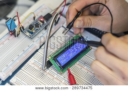 Persons Hands Attach Or Install Electric Silicon Chip Or Sensor