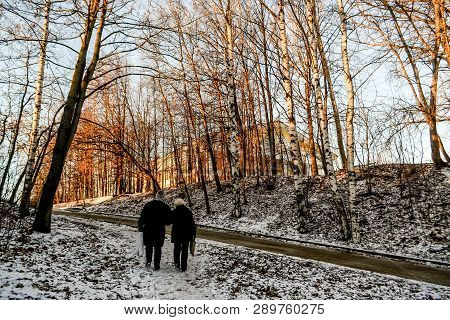 Two Men Are Walking Up The Hill