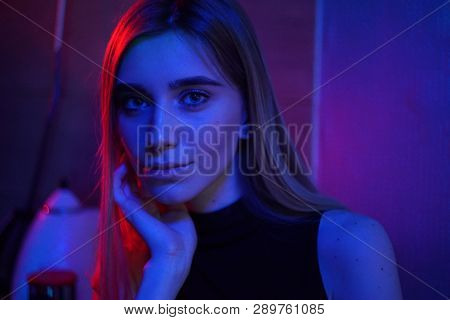 Sexy Young Beauty Woman Posing Over Night City Dramatic Red And Blue Neon Background